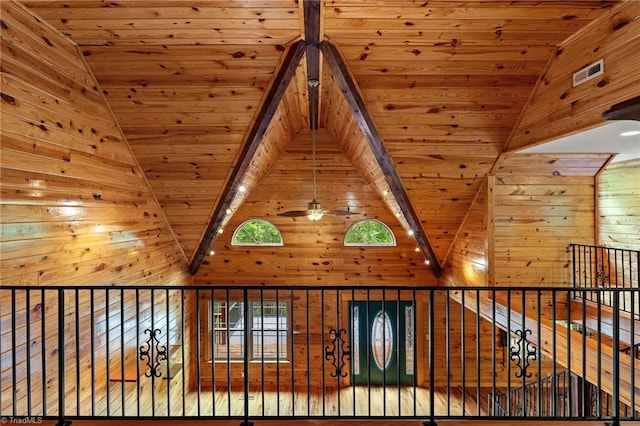 interior details with visible vents, wood walls, wood ceiling, and beam ceiling