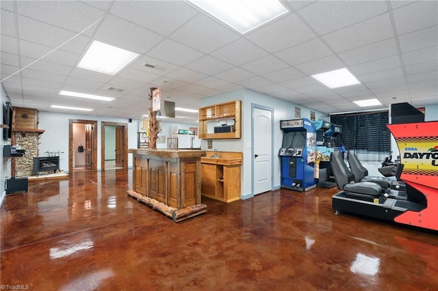 interior space featuring a drop ceiling, finished concrete floors, and visible vents