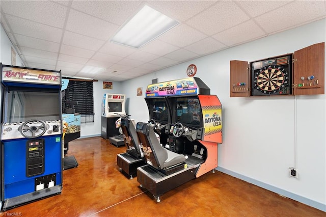 exercise room featuring baseboards and a drop ceiling