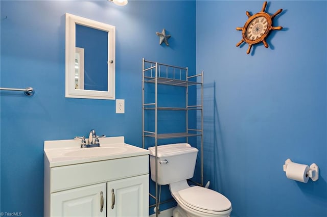 half bathroom with toilet and vanity