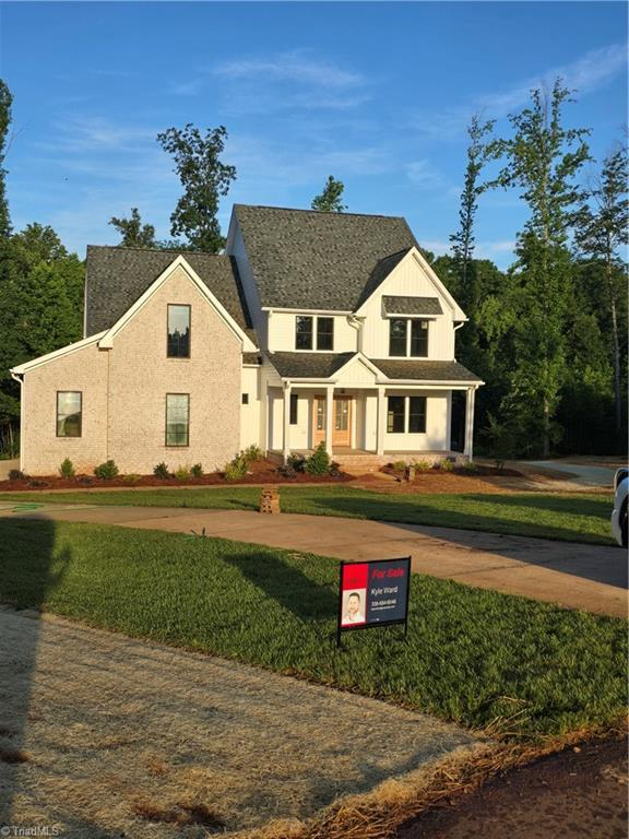 3501 Wesley Point Dr, Browns Summit, NC 27214 - modern farmhouse with a front lawn