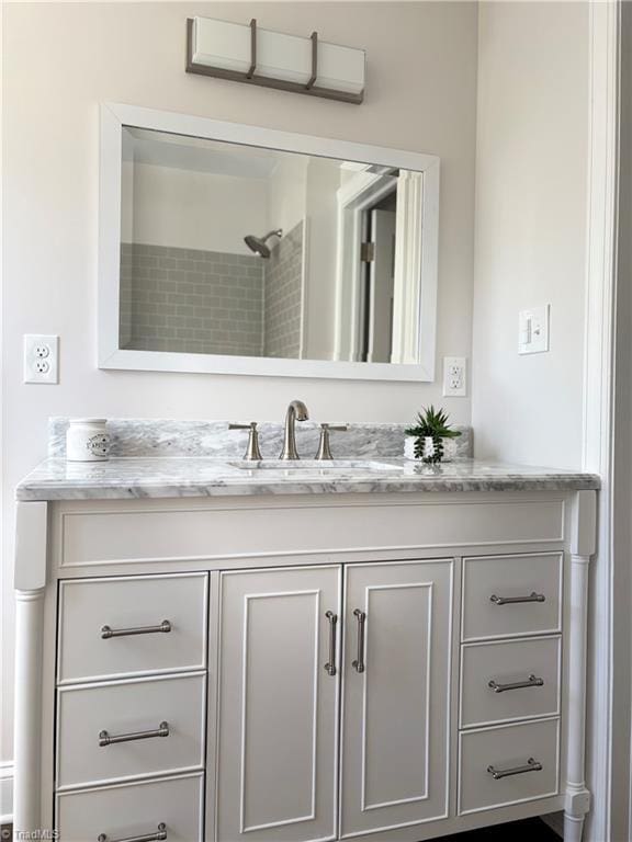 bathroom featuring vanity and a tile shower