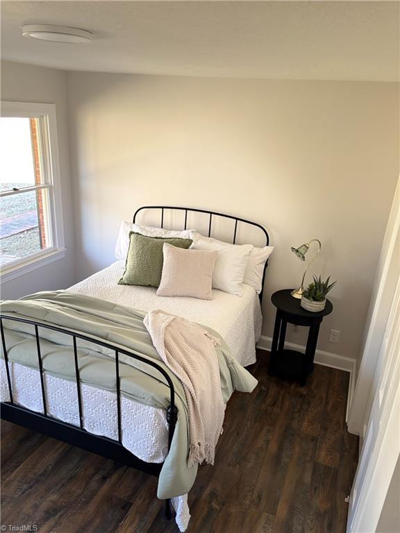 bedroom featuring dark wood-type flooring