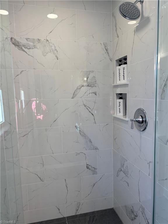 bathroom with a tile shower