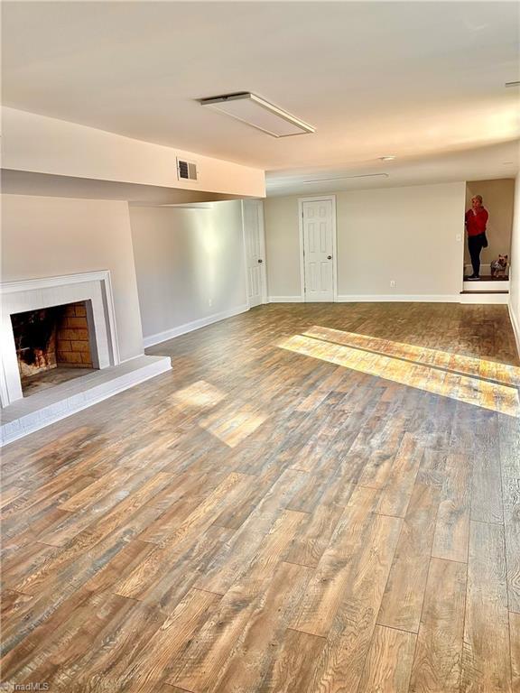 unfurnished living room featuring hardwood / wood-style flooring