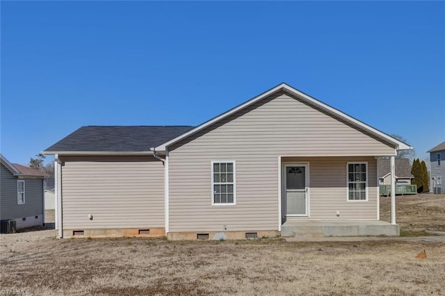 rear view of property featuring central AC, a yard, and a patio area