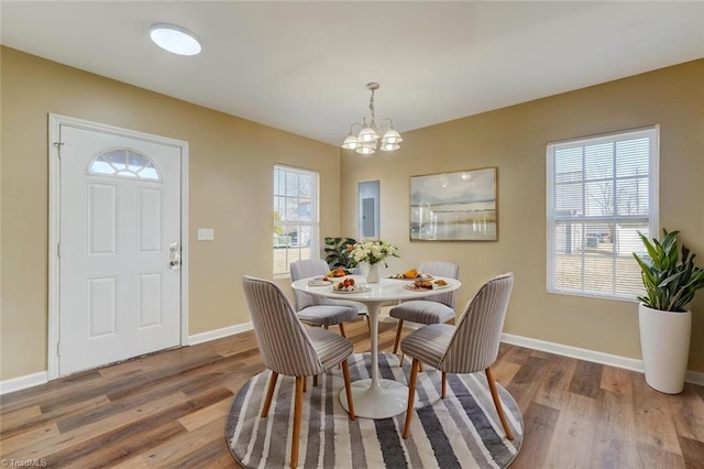 dining room featuring an inviting chandelier and wood-type flooring