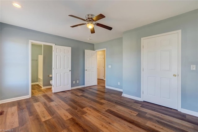 unfurnished bedroom featuring ceiling fan, dark hardwood / wood-style flooring, and ensuite bath