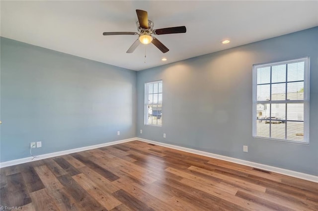 unfurnished room with hardwood / wood-style floors and ceiling fan