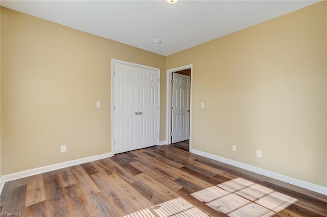 unfurnished bedroom with hardwood / wood-style flooring