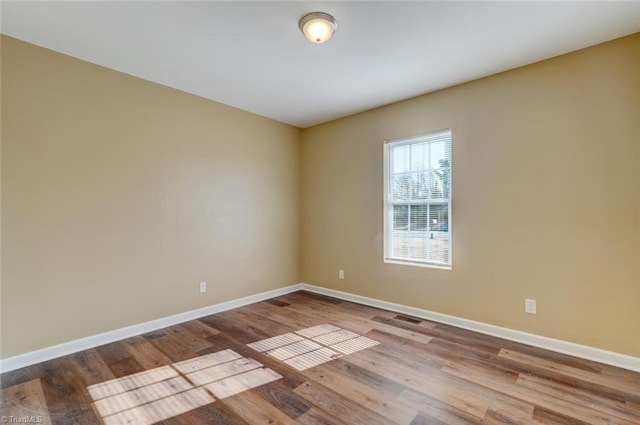 spare room with hardwood / wood-style flooring