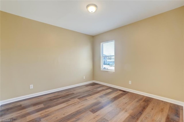 empty room with wood-type flooring