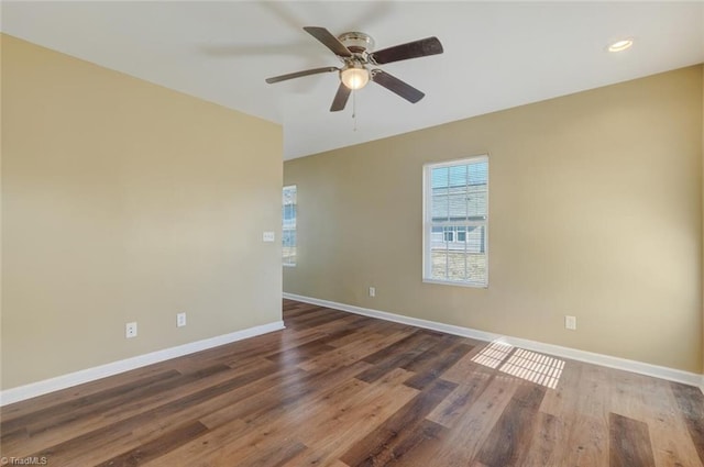 unfurnished room featuring ceiling fan and dark hardwood / wood-style flooring