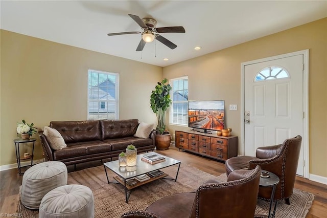 living room featuring hardwood / wood-style flooring and ceiling fan