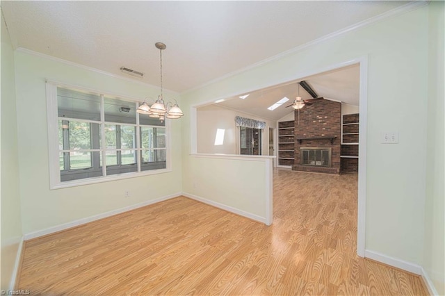 640 Summerest Ct, Kernersville, NC 27284 - spare room featuring wood finished floors, a fireplace, vaulted ceiling, ornamental molding, and a chandelier