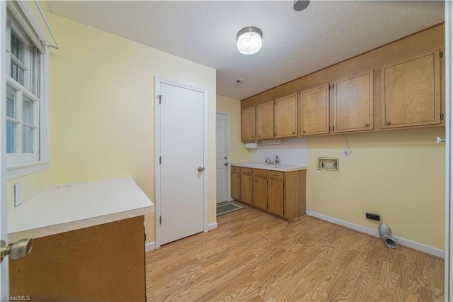 640 Summerest Ct, Kernersville, NC 27284 - laundry room featuring light wood-style flooring, cabinet space, hookup for a washing machine, and a textured ceiling