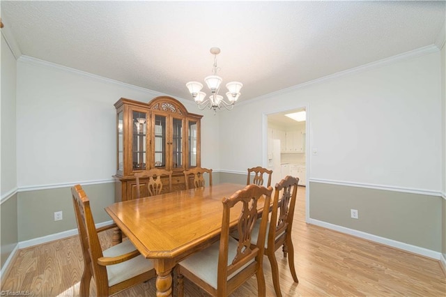 640 Summerest Ct, Kernersville, NC 27284 - dining space featuring a chandelier, light wood-type flooring, ornamental molding, and a textured ceiling