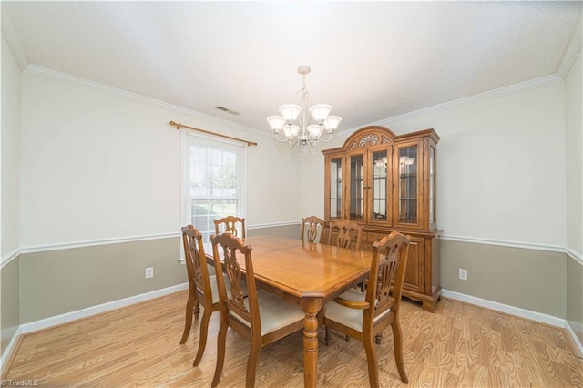 640 Summerest Ct, Kernersville, NC 27284 - dining area featuring a chandelier, light wood finished floors, and crown molding
