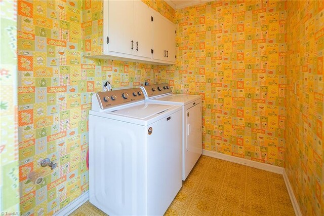 laundry room with cabinets and washer and dryer