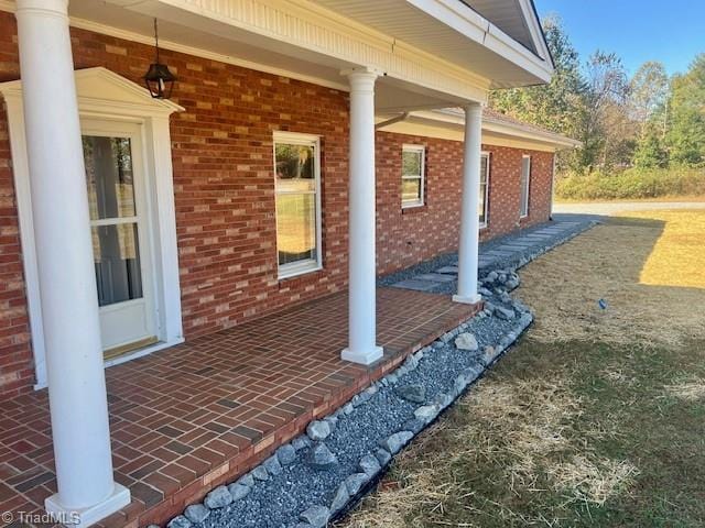 view of side of home with covered porch