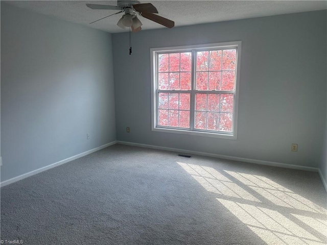 carpeted empty room featuring a textured ceiling and ceiling fan