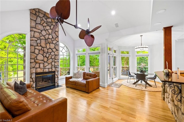 sunroom featuring plenty of natural light, vaulted ceiling, french doors, and a chandelier