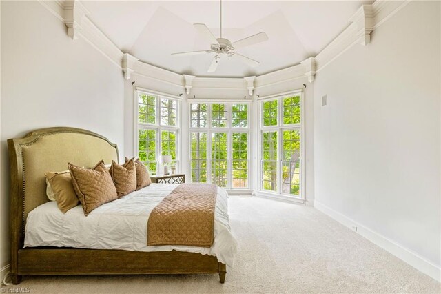 carpeted bedroom featuring baseboards and a ceiling fan