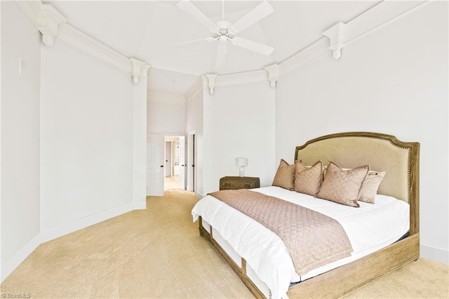 bedroom with light carpet, baseboards, a ceiling fan, crown molding, and decorative columns