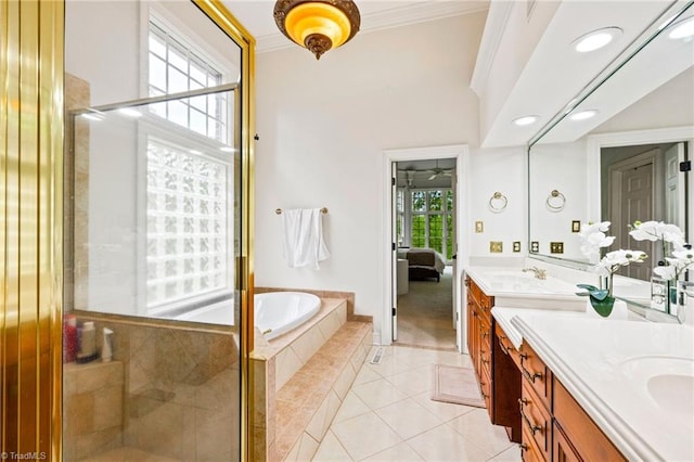 ensuite bathroom with double vanity, tile patterned floors, a stall shower, a bath, and ornamental molding