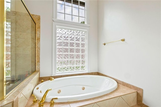 bathroom with a tub with jets