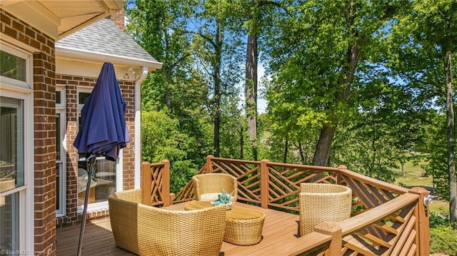 deck featuring view of wooded area