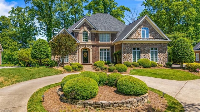 view of front of property with stone siding and a front yard