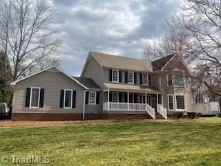 rear view of property with a porch and a yard