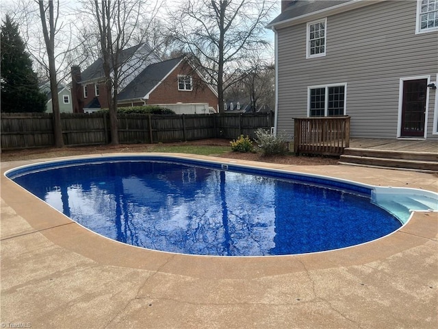 view of swimming pool with a deck, a fenced in pool, and a fenced backyard