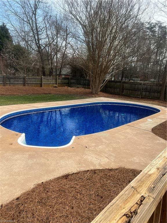 view of swimming pool with a fenced in pool, a fenced backyard, and a patio area