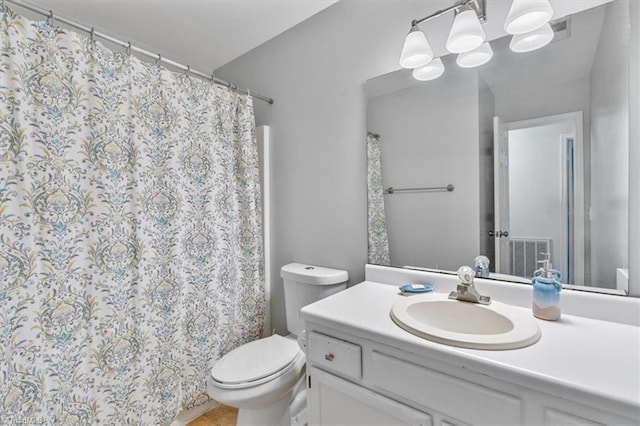 bathroom featuring vanity, toilet, and tile patterned flooring