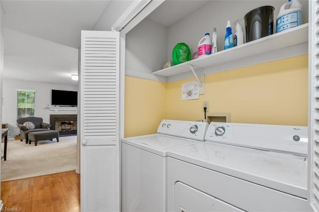 laundry area featuring hardwood / wood-style flooring and washing machine and dryer