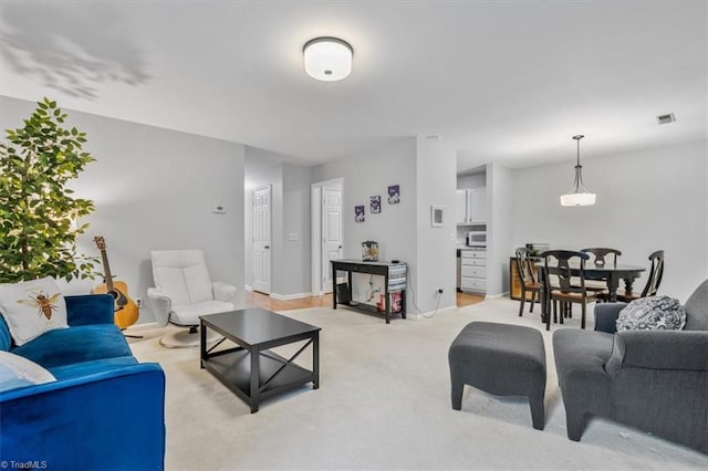 living room featuring light carpet