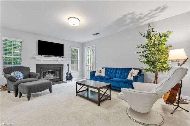 living room featuring plenty of natural light and light colored carpet