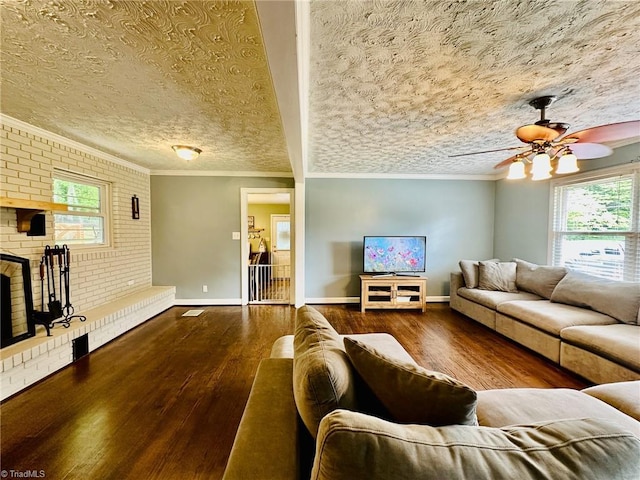 2025 Pope Rd, Winston-Salem, NC 27127 - living area with wood finished floors, a ceiling fan, brick wall, crown molding, and a brick fireplace