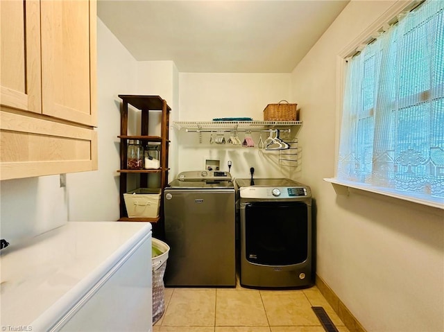 2025 Pope Rd, Winston-Salem, NC 27127 - washroom featuring washing machine and dryer, cabinet space, light tile patterned floors, and baseboards