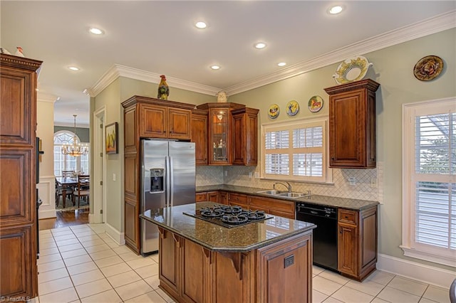 kitchen featuring black dishwasher, decorative backsplash, light tile patterned floors, and a kitchen island