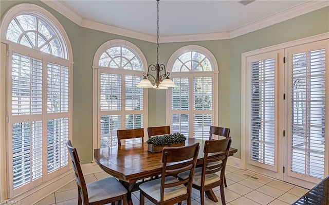 tiled dining area with crown molding and a chandelier