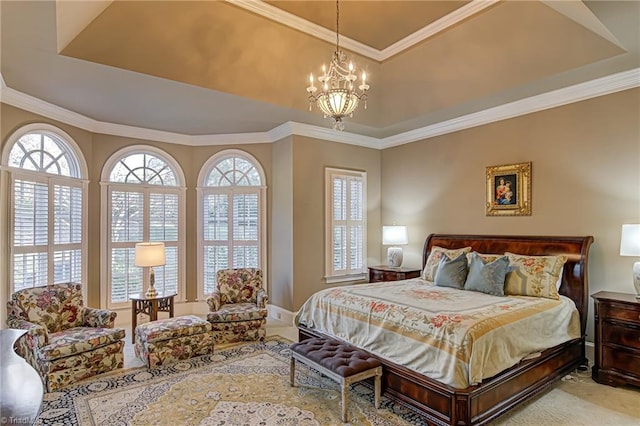 bedroom with a raised ceiling, ornamental molding, and an inviting chandelier