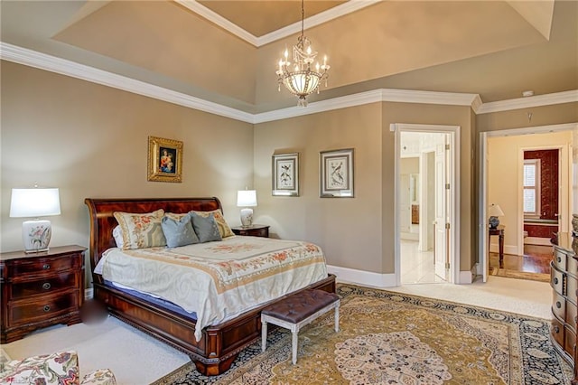 bedroom with crown molding, an inviting chandelier, connected bathroom, a tray ceiling, and light carpet