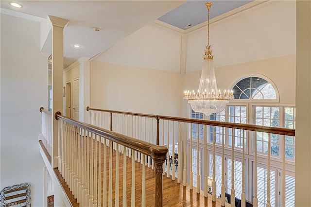 hall with an inviting chandelier and hardwood / wood-style flooring