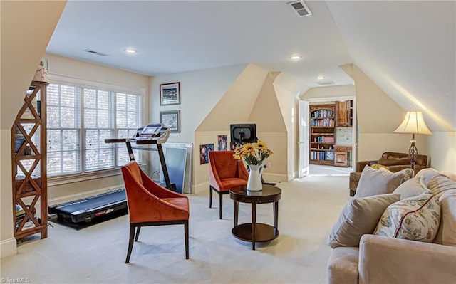 sitting room with light carpet and vaulted ceiling