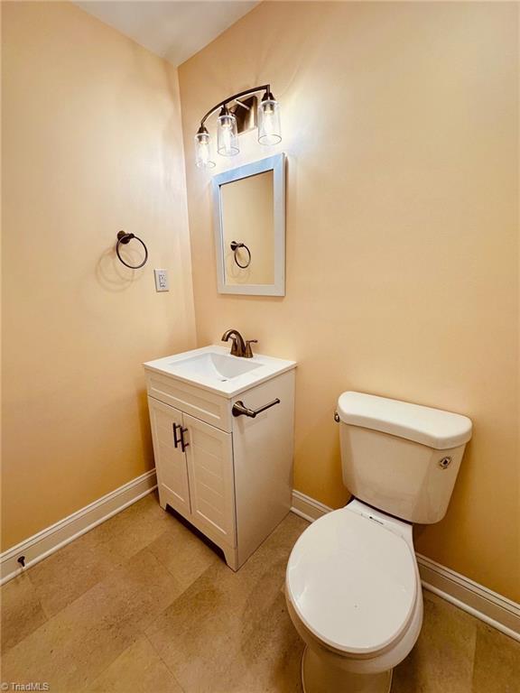 5670 Plantation Dr, Winston-Salem, NC 27105 - bathroom with vanity, baseboards, and toilet