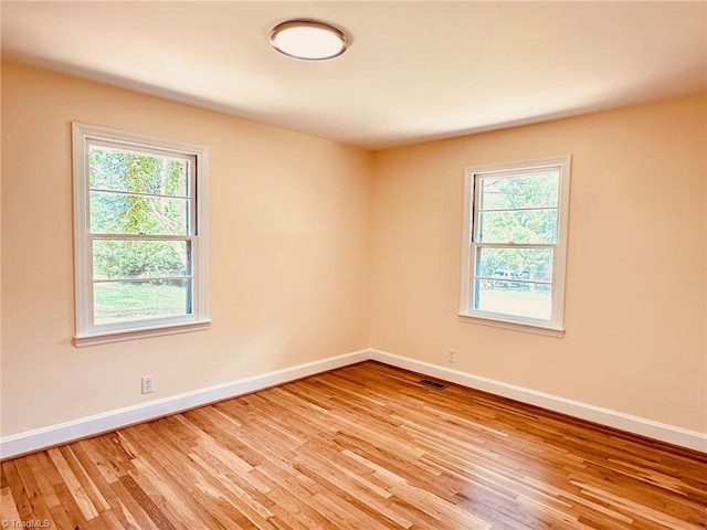 5670 Plantation Dr, Winston-Salem, NC 27105 - empty room with baseboards, light wood-style floors, and plenty of natural light