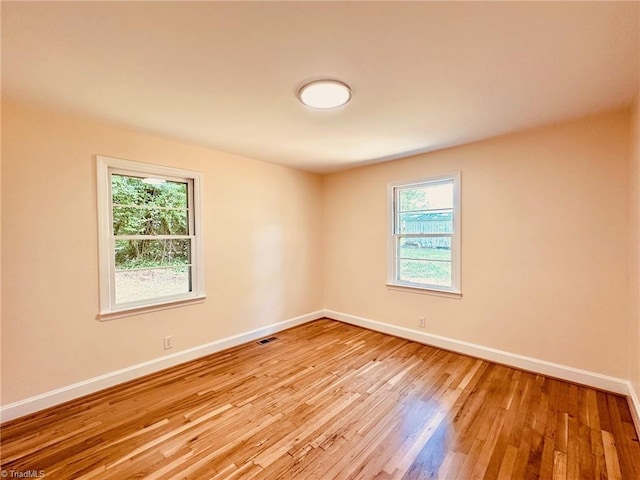 5670 Plantation Dr, Winston-Salem, NC 27105 - unfurnished room with healthy amount of natural light, light wood-style flooring, and baseboards
